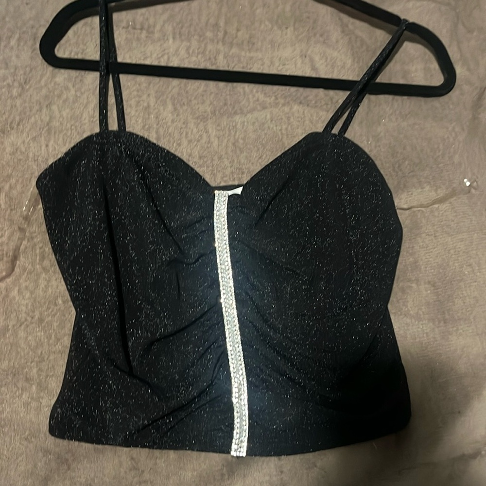 Very comfortable and stretchy material, was only worn once all gems still there.